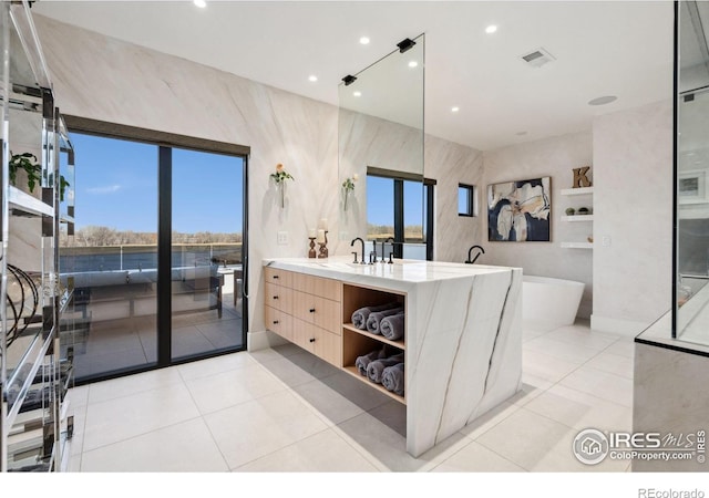 bathroom featuring a freestanding tub, recessed lighting, vanity, visible vents, and tile patterned floors