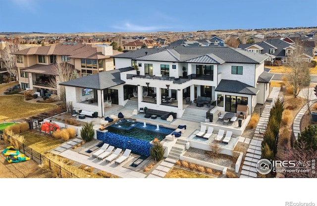 rear view of property featuring a fenced backyard, a residential view, outdoor dry bar, an outdoor hangout area, and outdoor dining area