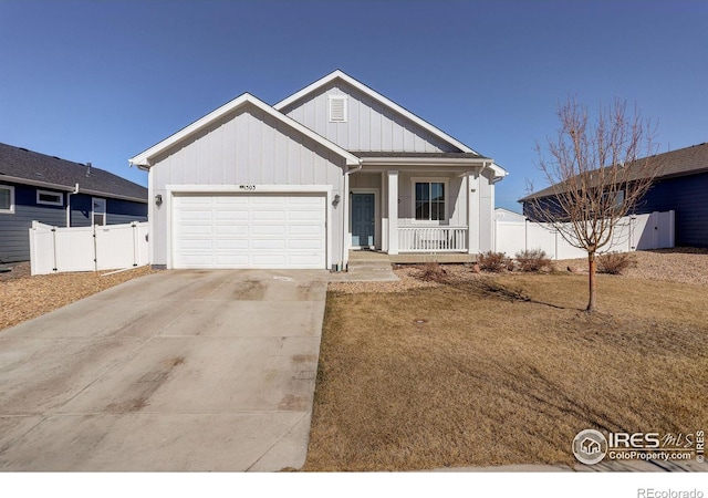 view of front of property featuring a porch, an attached garage, fence, concrete driveway, and board and batten siding