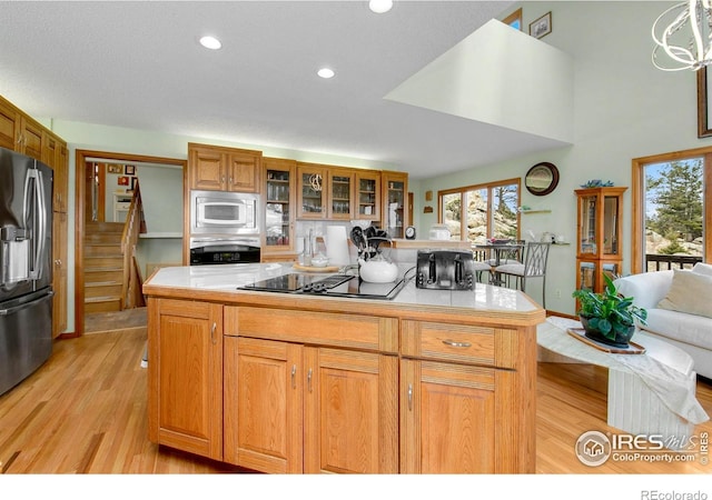 kitchen featuring light countertops, appliances with stainless steel finishes, and plenty of natural light