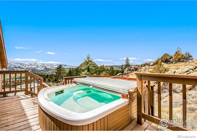 wooden terrace with a mountain view and a hot tub