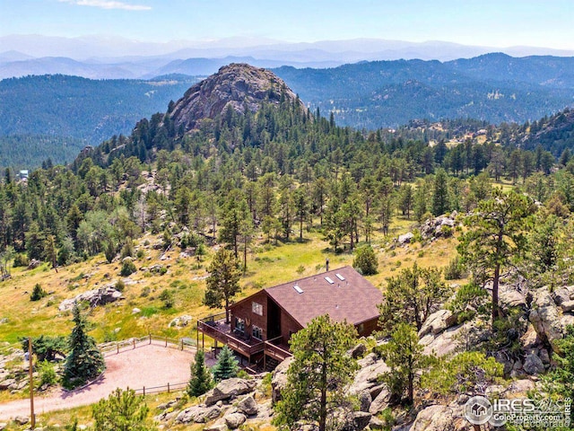 aerial view featuring a mountain view and a view of trees