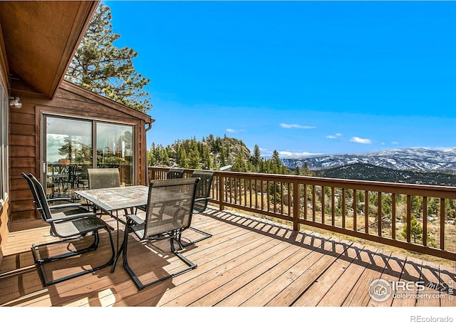 131 Mount Apiatan Ct, Livermore, CO 80536 - wooden terrace with outdoor dining space and a mountain view