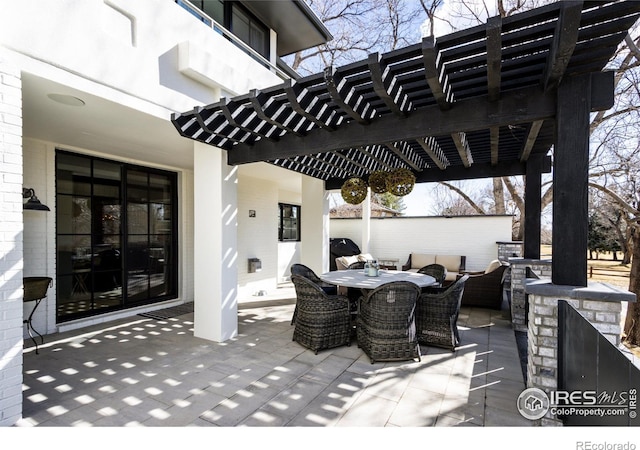 view of patio featuring outdoor dining area and a pergola