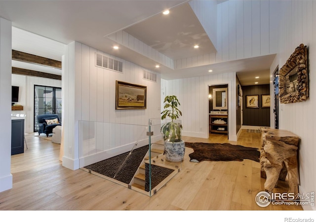 corridor with light wood-type flooring, baseboards, visible vents, and recessed lighting