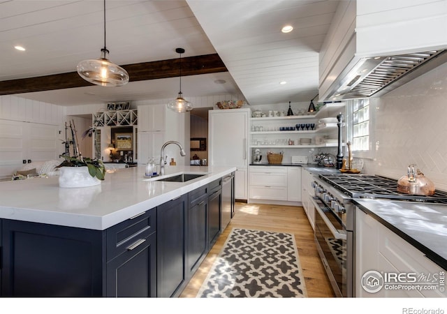 kitchen with custom range hood, beam ceiling, stainless steel appliances, and a sink