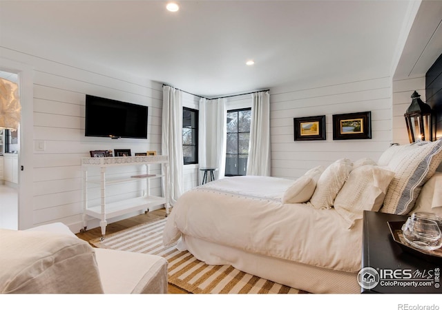 bedroom with recessed lighting and wood finished floors