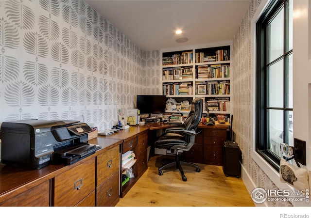 home office featuring light wood-style flooring and wallpapered walls