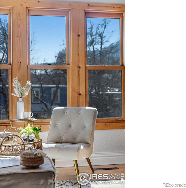 living area featuring baseboards and wood finished floors