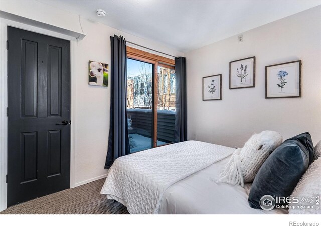 carpeted bedroom featuring access to outside and baseboards