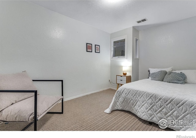 bedroom featuring baseboards, visible vents, and carpet flooring