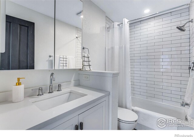 bathroom with shower / tub combo, vanity, and toilet