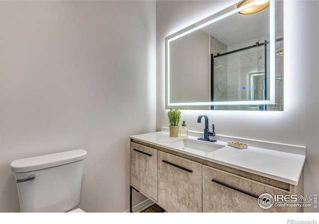 full bathroom with toilet, an enclosed shower, and vanity