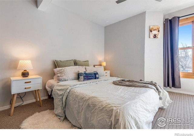 bedroom with carpet floors, baseboards, and vaulted ceiling