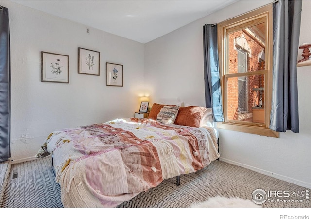 bedroom featuring carpet flooring and baseboards