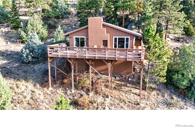 back of house with a wooden deck