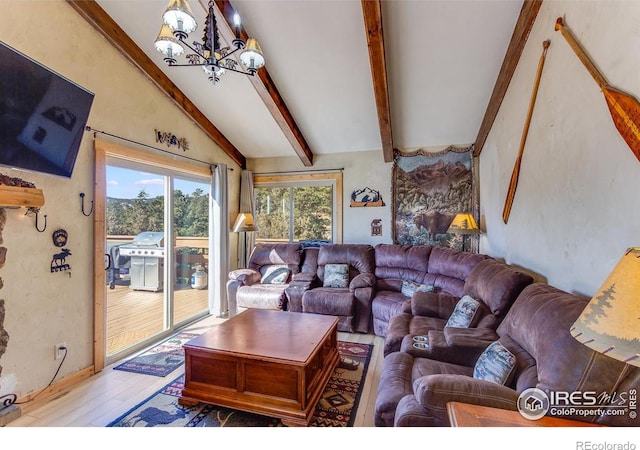 living area featuring a chandelier, lofted ceiling with beams, and wood finished floors