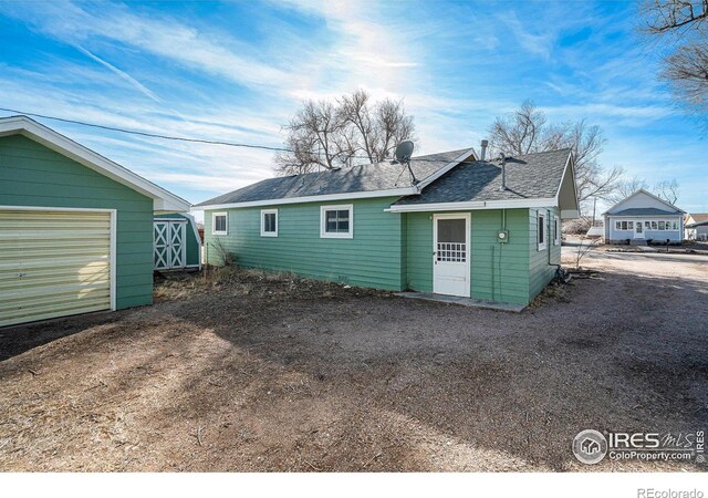 back of property with an outdoor structure