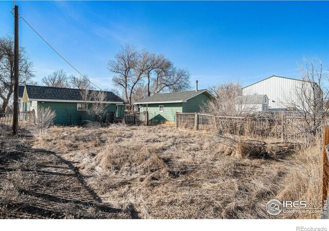 back of house featuring fence