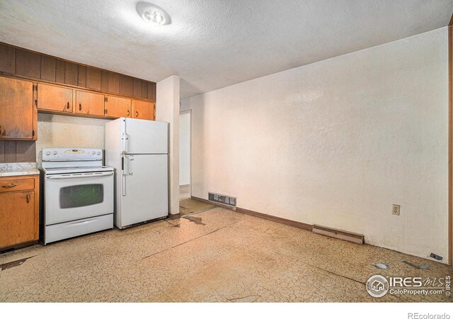 kitchen featuring light countertops, white appliances, brown cabinetry, and visible vents