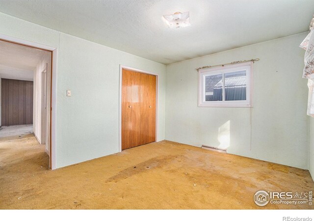 carpeted spare room with visible vents