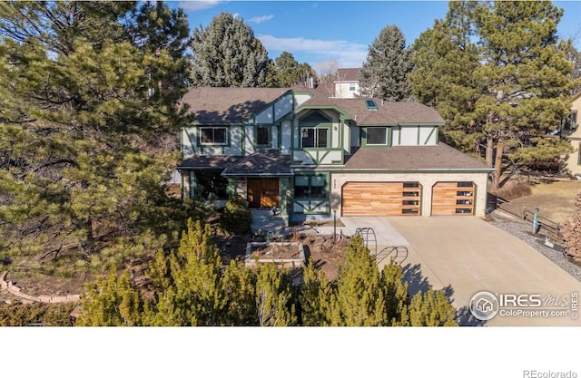 tudor-style house with concrete driveway