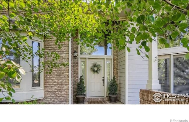 property entrance with brick siding