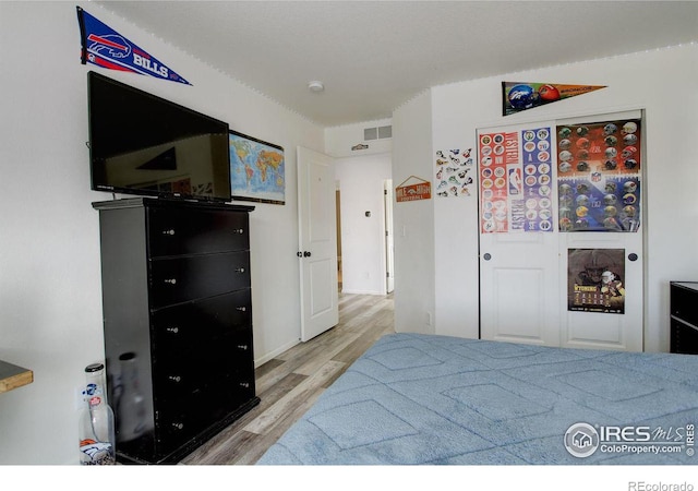 bedroom with wood finished floors and visible vents