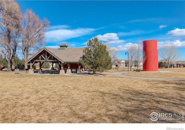 surrounding community with a yard and a gazebo