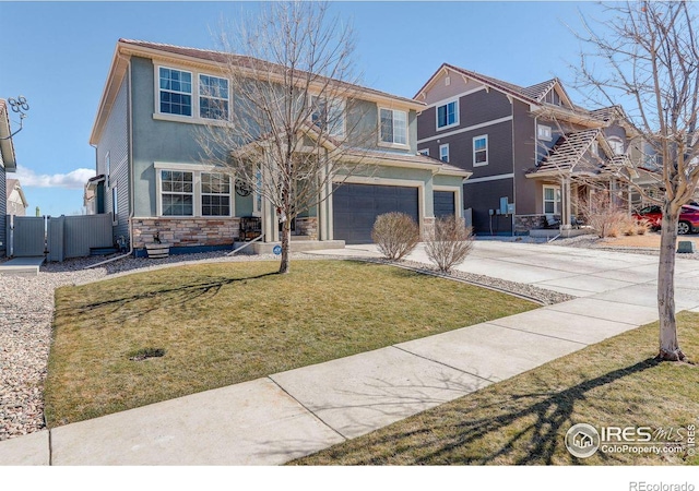 view of front of house with an attached garage, fence, driveway, stone siding, and a front lawn