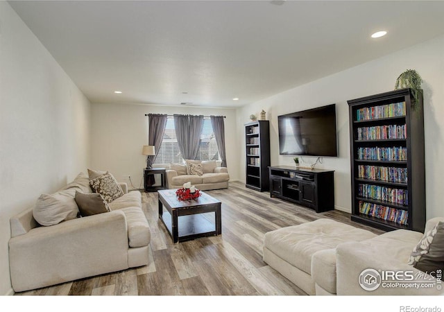 living room featuring light wood-style flooring and recessed lighting