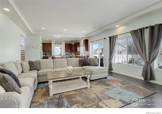 living room with baseboards, dark wood-type flooring, and recessed lighting