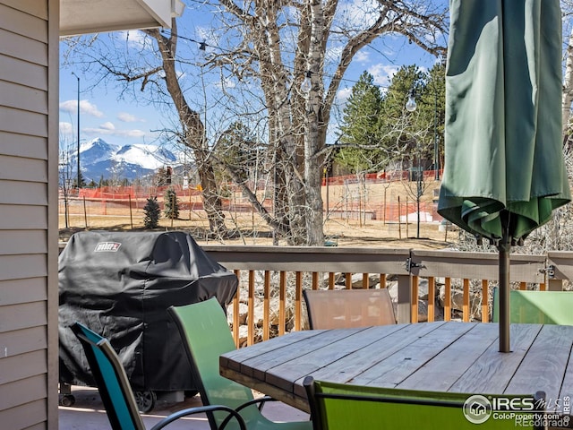 deck featuring a mountain view and area for grilling