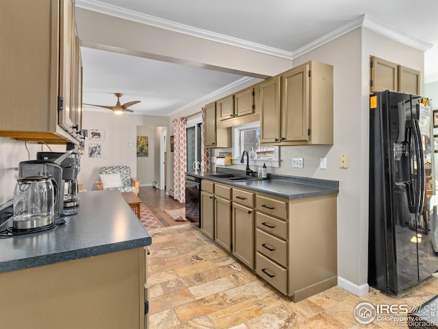 kitchen with crown molding, dark countertops, a sink, beverage cooler, and black fridge