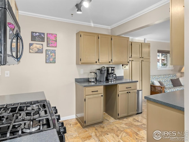 kitchen with dark countertops, black appliances, baseboards, and ornamental molding