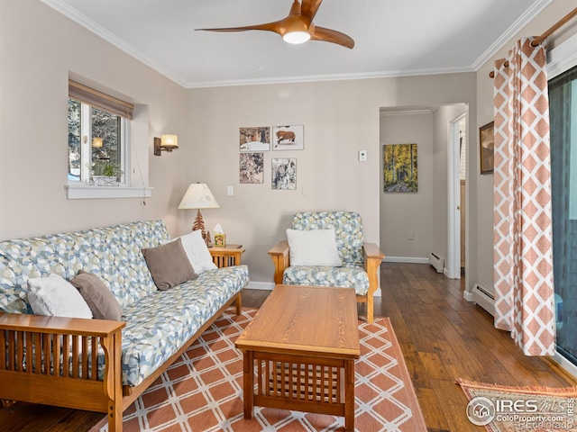 living room with a baseboard radiator, hardwood / wood-style flooring, baseboards, and ornamental molding