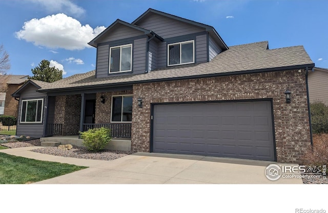 view of front of property with a garage, covered porch, driveway, and brick siding