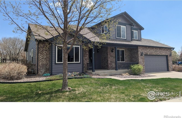 view of front of house with an attached garage, a porch, a front yard, and brick siding