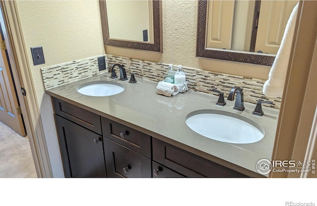 full bathroom with double vanity, a sink, and decorative backsplash