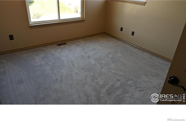 spare room with carpet floors and visible vents