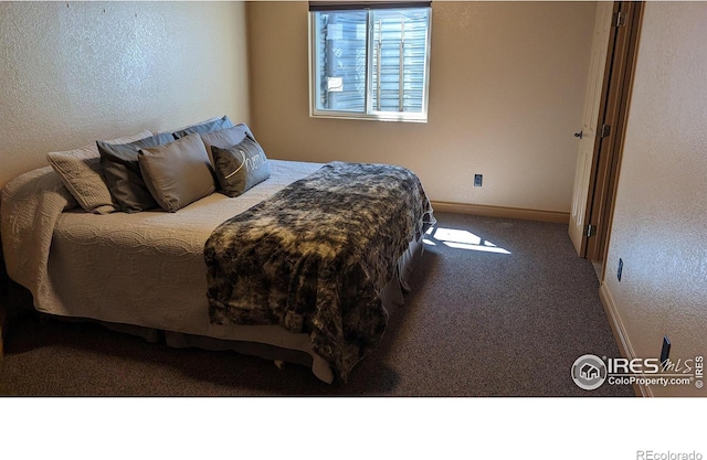 bedroom with baseboards and carpet flooring