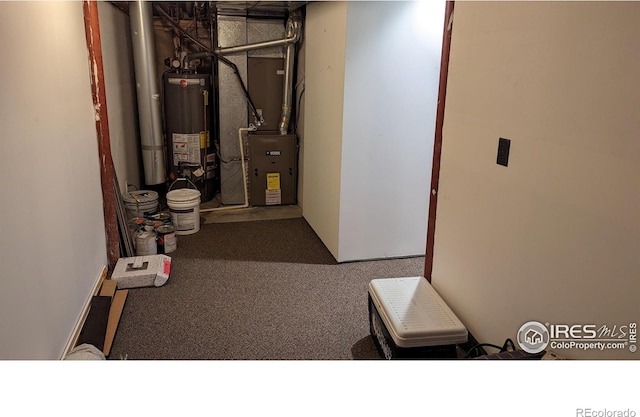 utility room featuring gas water heater and heating unit