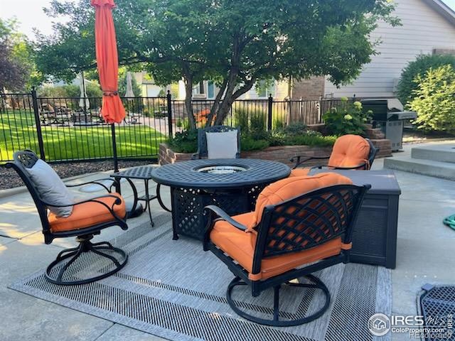 view of patio / terrace with a grill and fence