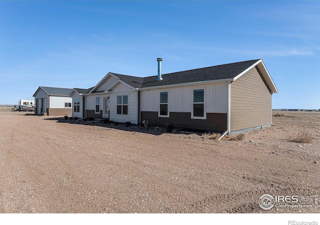 rear view of property featuring a garage