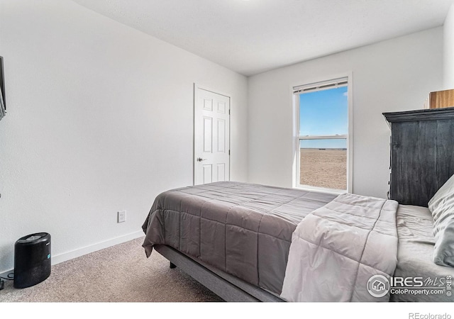 bedroom with carpet and baseboards