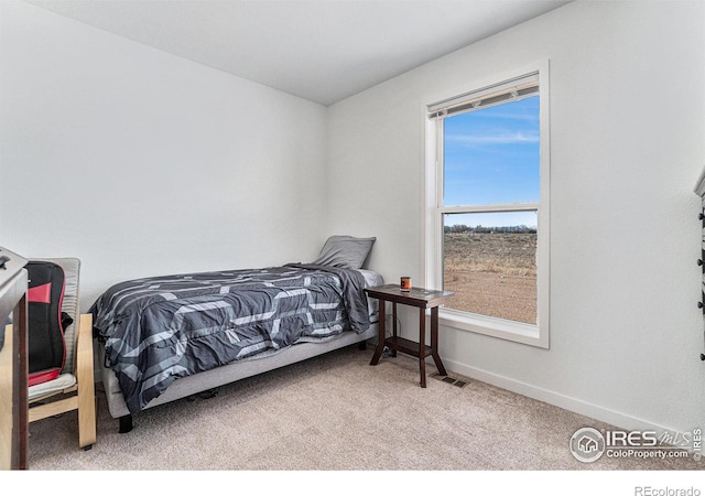 carpeted bedroom featuring baseboards