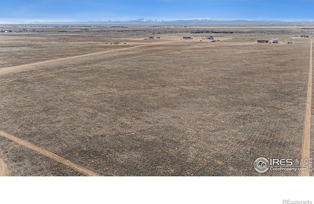 drone / aerial view featuring a rural view and a mountain view