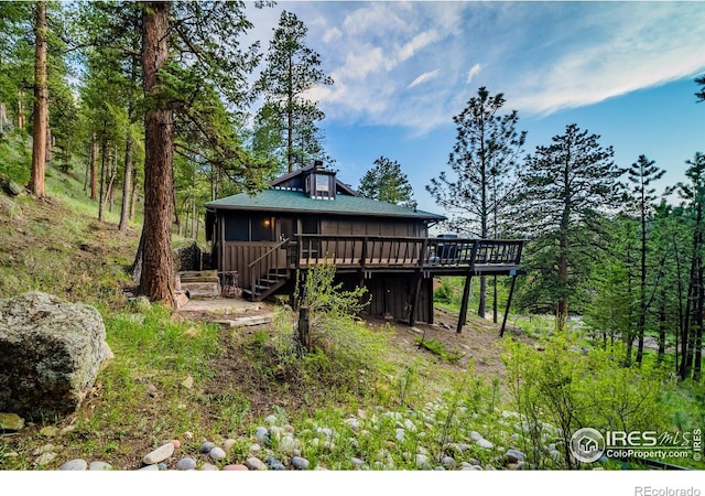 view of front of house with a sunroom and a deck