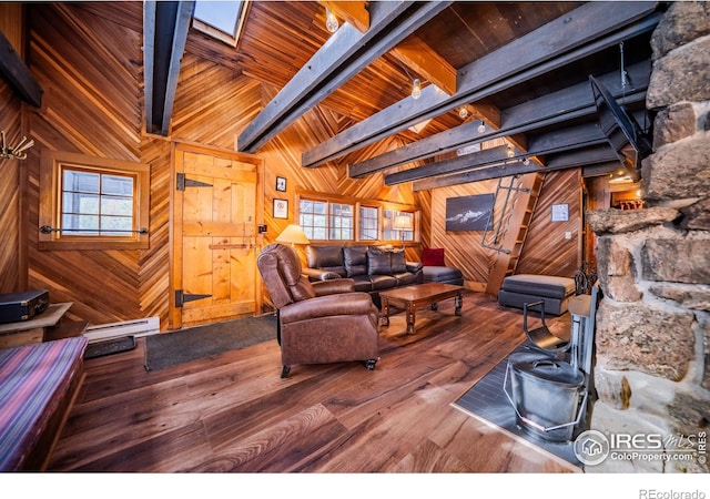 living room featuring a baseboard heating unit, wood walls, and wood finished floors