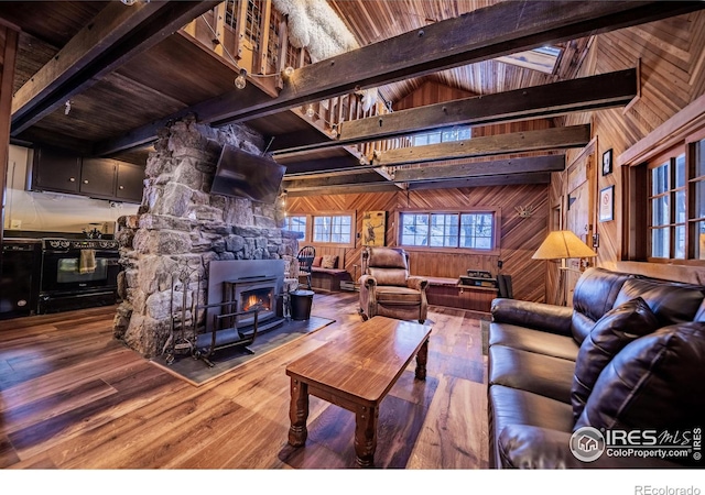 living room featuring beam ceiling, high vaulted ceiling, wood finished floors, wood walls, and wood ceiling